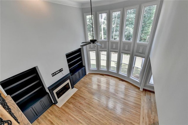 1723 Woodbow Path, Dacula, GA 30019 - unfurnished living room with a ceiling fan, light wood finished floors, and crown molding