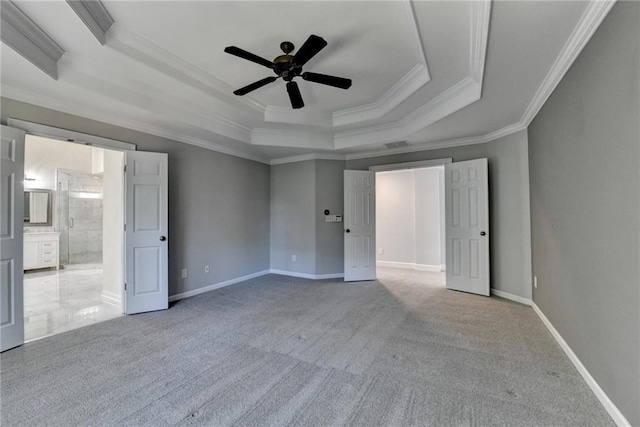 1723 Woodbow Path, Dacula, GA 30019 - unfurnished bedroom featuring a tray ceiling, ornamental molding, carpet flooring, ensuite bath, and a ceiling fan