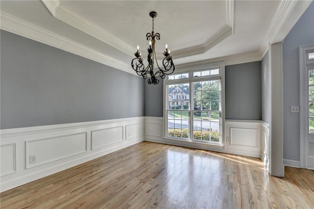 1723 Woodbow Path, Dacula, GA 30019 - unfurnished room featuring a chandelier, plenty of natural light, crown molding, wood finished floors, and a tray ceiling