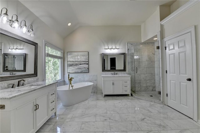 1723 Woodbow Path, Dacula, GA 30019 - bathroom featuring a shower stall, two vanities, vaulted ceiling, a freestanding tub, and marble look tile flooring