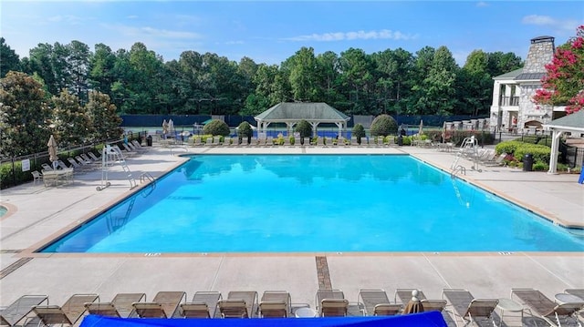 1723 Woodbow Path, Dacula, GA 30019 - community pool featuring a patio and view of wooded area