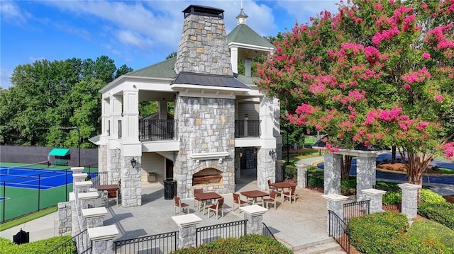 1723 Woodbow Path, Dacula, GA 30019 - view of community featuring a patio area and a tennis court