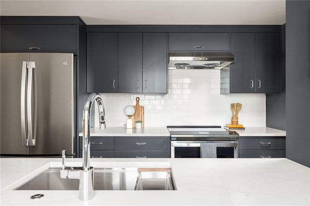 kitchen with appliances with stainless steel finishes, ventilation hood, sink, and backsplash