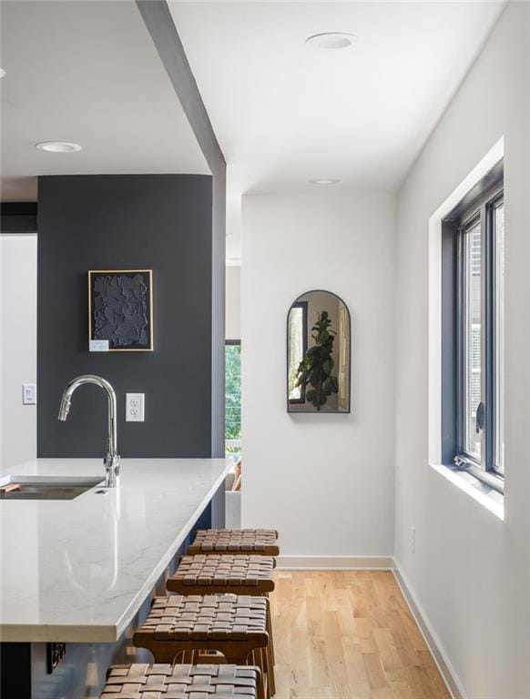 interior space featuring sink and light hardwood / wood-style flooring