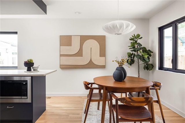 dining space with light wood-type flooring