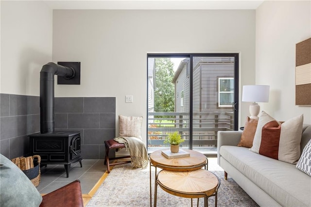 living room featuring tile patterned flooring and a wood stove