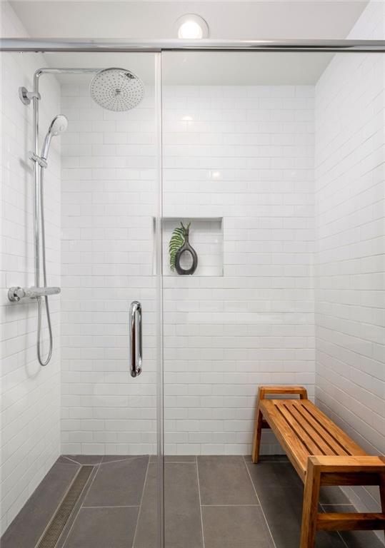 bathroom featuring tile patterned flooring and a shower with door