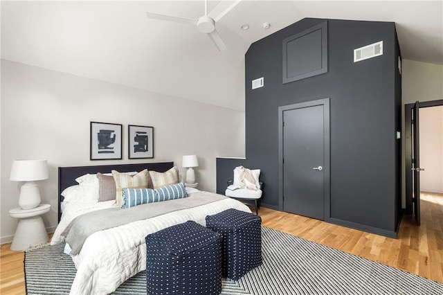 bedroom featuring hardwood / wood-style flooring, ceiling fan, and high vaulted ceiling