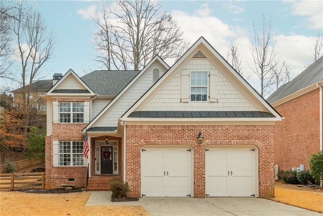 view of front facade with concrete driveway, crawl space, a standing seam roof, an attached garage, and brick siding