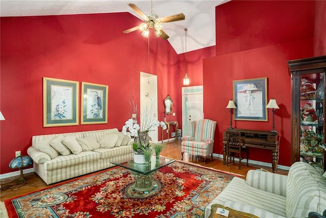 living room with wood-type flooring, high vaulted ceiling, and ceiling fan