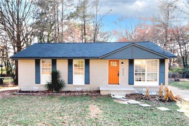 ranch-style house with crawl space, a front lawn, and brick siding