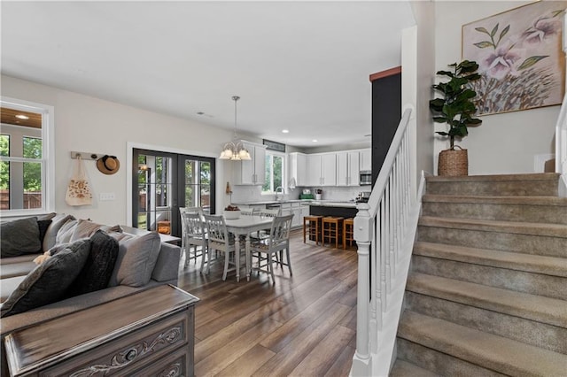 dining area with stairs, recessed lighting, dark wood finished floors, and a chandelier
