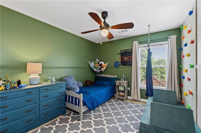 carpeted bedroom featuring a ceiling fan and baseboards