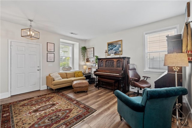 living area with a chandelier and wood finished floors