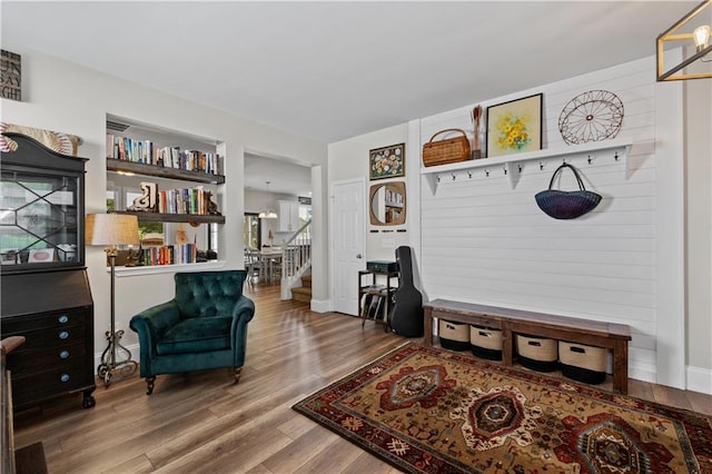 living area with wood finished floors and stairway