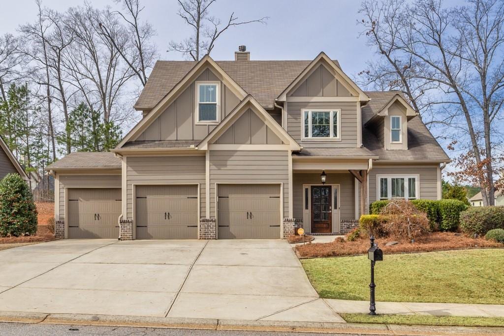 craftsman-style home with a front yard and a garage