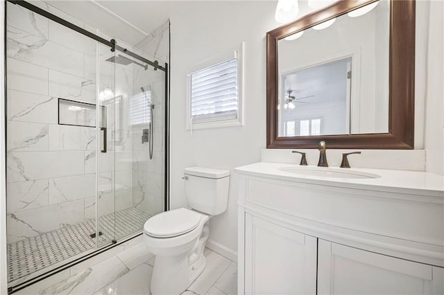 bathroom with ceiling fan, vanity, toilet, and a shower with door