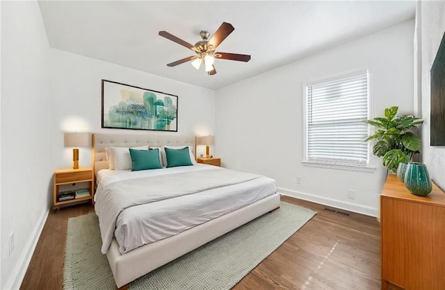 bedroom featuring ceiling fan and dark hardwood / wood-style flooring