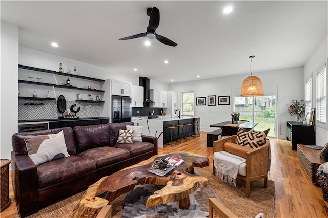 210 Locust St NE, Atlanta, GA 30317 - living room featuring indoor bar, a healthy amount of sunlight, and light wood finished floors