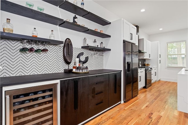 210 Locust St NE, Atlanta, GA 30317 - interior space with tasteful backsplash, light wood-type flooring, a bar, black appliances, and wine cooler
