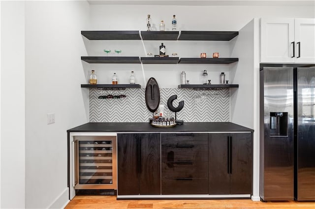 210 Locust St NE, Atlanta, GA 30317 - bar with a dry bar, stainless steel fridge with ice dispenser, light wood-style flooring, decorative backsplash, and wine cooler