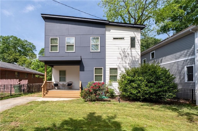 210 Locust St NE, Atlanta, GA 30317 - back of property with a lawn, fence, and covered porch
