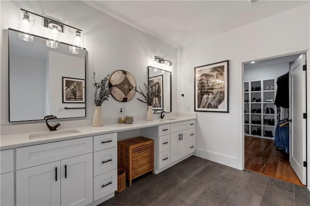 210 Locust St NE, Atlanta, GA 30317 - bathroom with double vanity, baseboards, and a sink