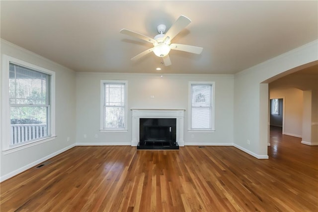 unfurnished living room featuring ornamental molding, dark hardwood / wood-style floors, and ceiling fan