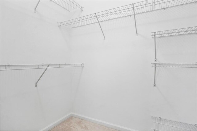 spare room featuring baseboards, visible vents, and light carpet