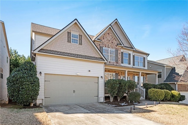 craftsman inspired home featuring covered porch and a garage