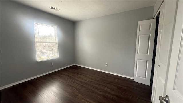 spare room featuring dark hardwood / wood-style flooring