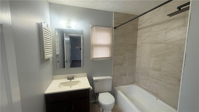 full bathroom with a textured ceiling, vanity, tiled shower / bath combo, and toilet