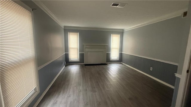 spare room featuring dark hardwood / wood-style flooring and ornamental molding