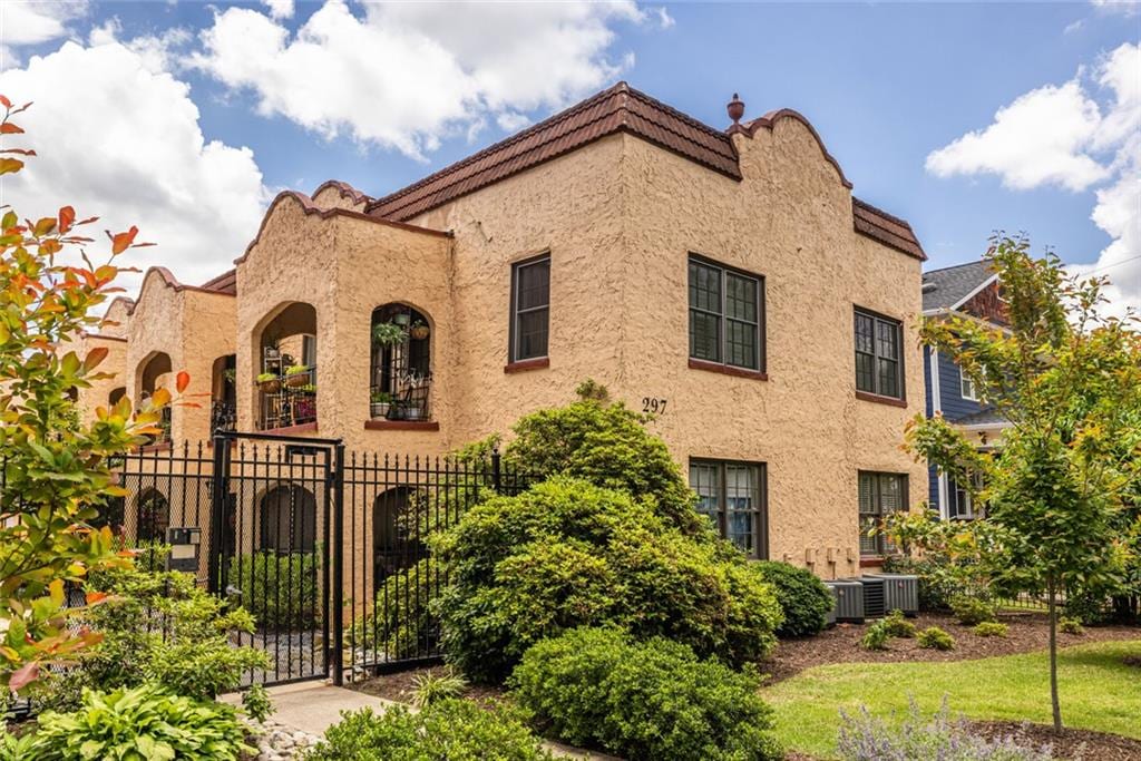 297 Atlanta Ave SE Unit 8, Atlanta, GA 30315 - view of front of house with fence, stucco siding, and a gate