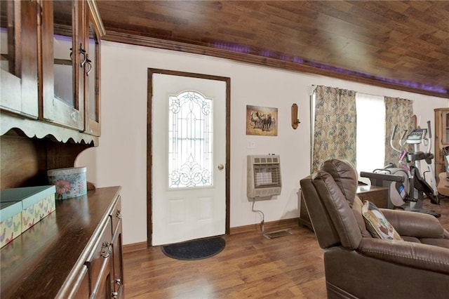 entryway with dark wood-type flooring, wooden ceiling, and heating unit