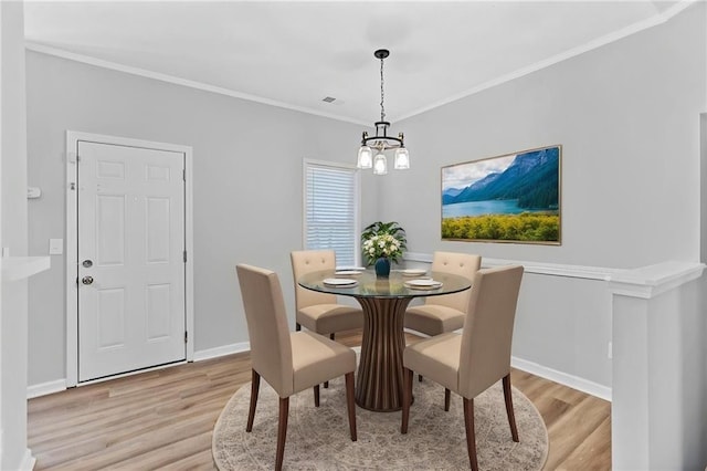 3315 Brookfield Dr, Austell, GA 30106 - dining room with light wood-type flooring, a chandelier, baseboards, and crown molding