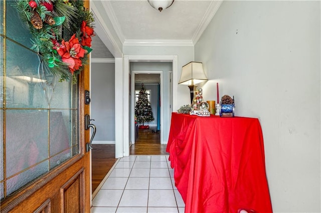 foyer entrance with ornamental molding and light hardwood / wood-style flooring