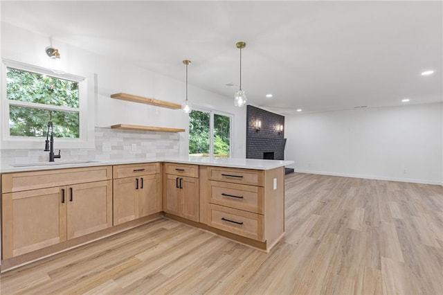 6142 Hutchins Dr, Buford, GA 30518 - kitchen with light brown cabinetry, a sink, light wood-style floors, light countertops, and recessed lighting