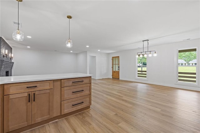 6142 Hutchins Dr, Buford, GA 30518 - kitchen featuring open floor plan, light wood-type flooring, a brick fireplace, light countertops, and recessed lighting