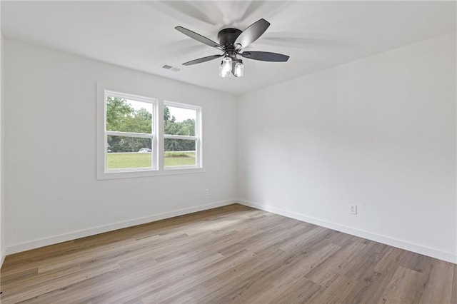 6142 Hutchins Dr, Buford, GA 30518 - unfurnished room with light wood-style flooring, a ceiling fan, and baseboards