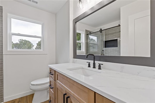 6142 Hutchins Dr, Buford, GA 30518 - full bath with vanity, plenty of natural light, an enclosed shower, and toilet