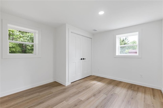 6142 Hutchins Dr, Buford, GA 30518 - unfurnished bedroom featuring baseboards, light wood-type flooring, a closet, and recessed lighting