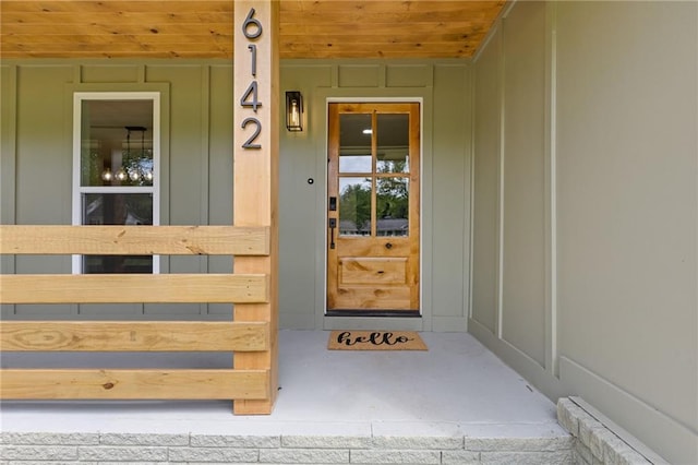 6142 Hutchins Dr, Buford, GA 30518 - doorway to property with board and batten siding and a porch
