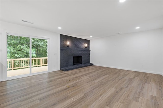6142 Hutchins Dr, Buford, GA 30518 - unfurnished living room with light wood finished floors, a fireplace, recessed lighting, and baseboards