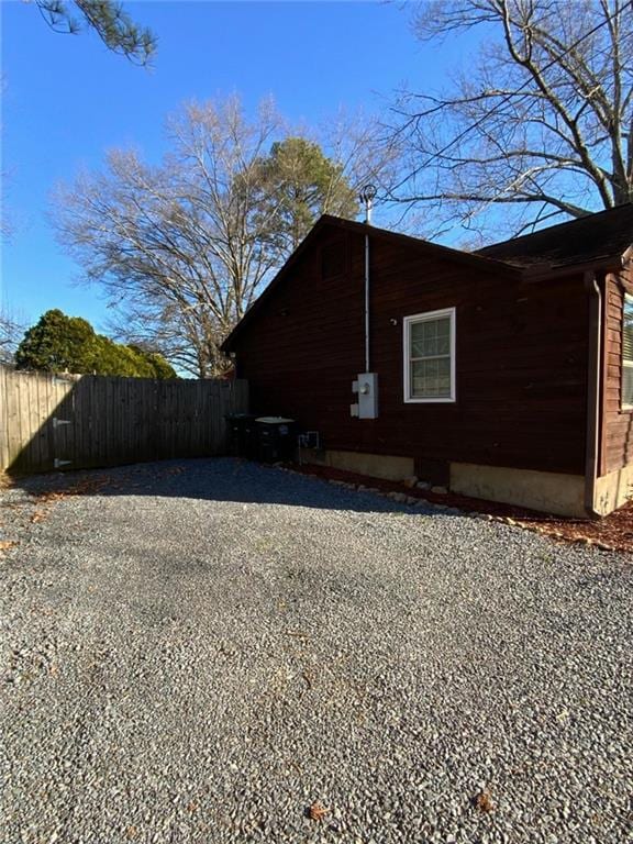 view of side of property featuring fence