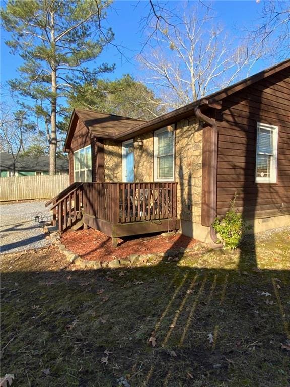 view of side of property featuring fence