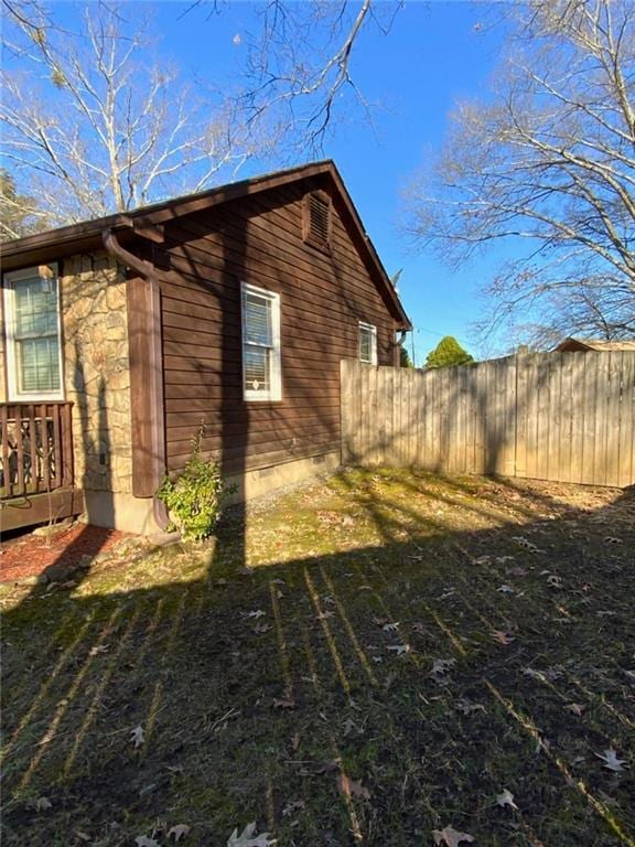 view of property exterior featuring fence