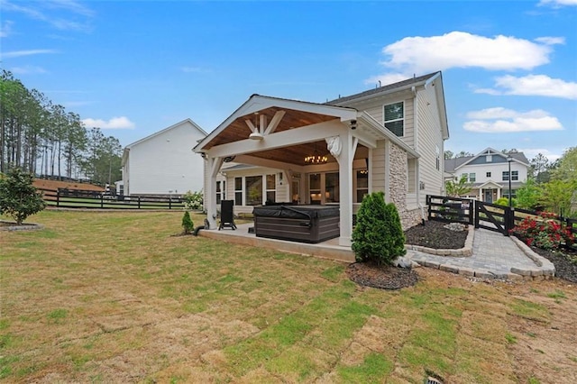 7935 Welch Ml, Ball Ground, GA 30107 - rear view of property with a fenced backyard, a yard, a patio, stone siding, and a hot tub