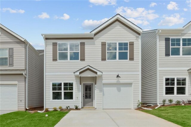 view of front of property with a garage and a front yard