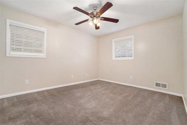 carpeted spare room featuring ceiling fan